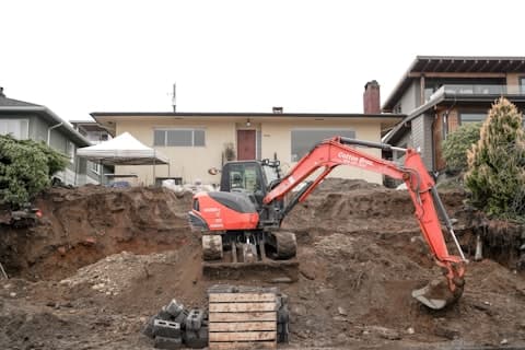 Trench backfilled beside the house at the end of the day